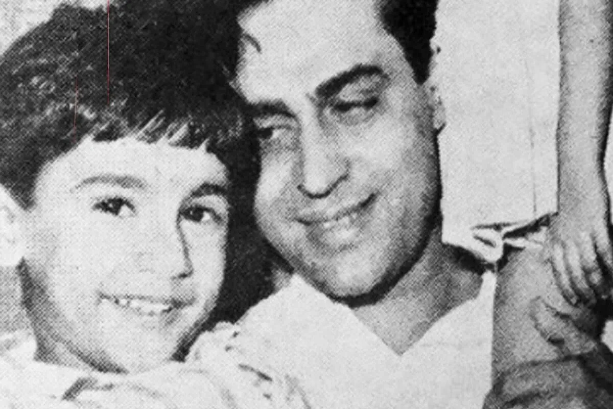 A vintage style photo of a smiling 80s Bollywood actor