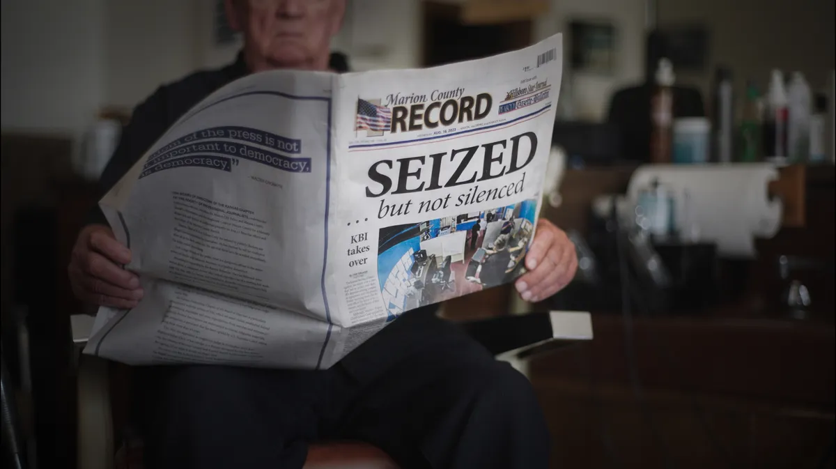A still image from the documentary 'Seized' showing a newspaper office.