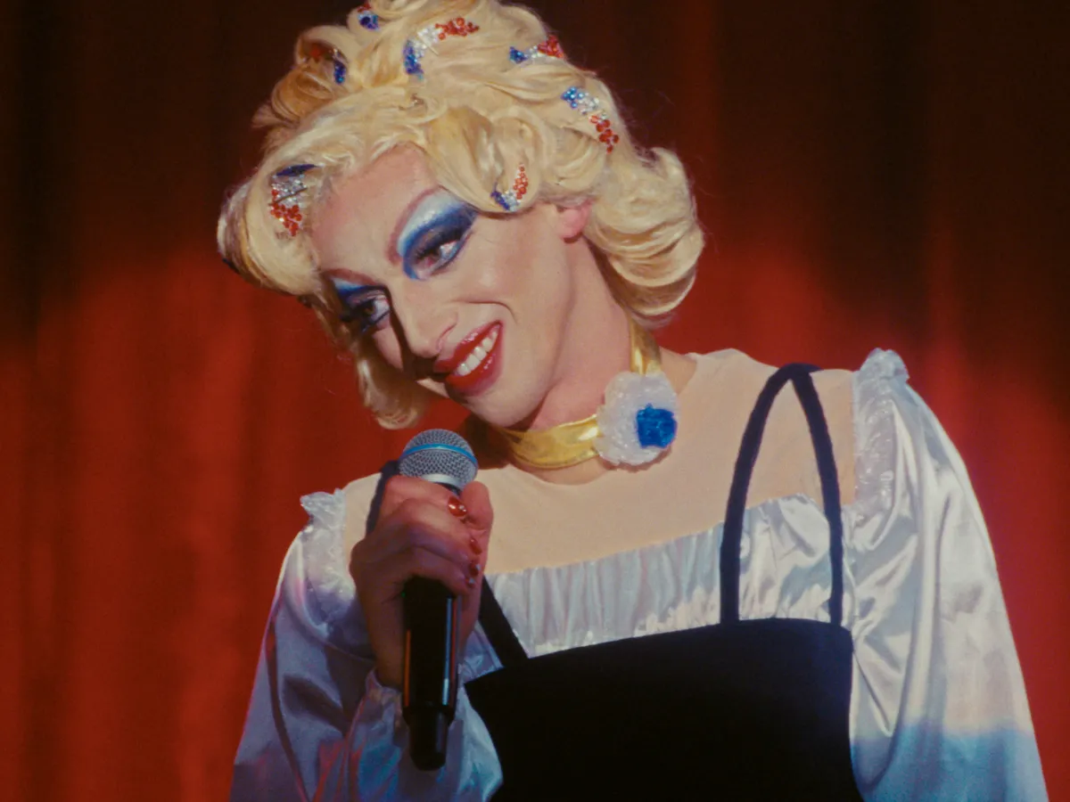 A conceptual image of a colorful drag queen outfit next to a traditional mother's coat