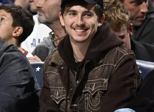 Timothée Chalamet looking stylish and tired at a basketball game