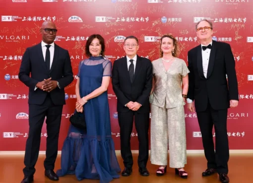 Three film festival directors from Berlin, Toronto, and Hong Kong discussing a panel in Shanghai, possibly smiling and gesturing.