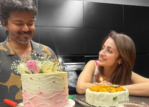 Trisha Krishnan and Vijay posing together at a party.