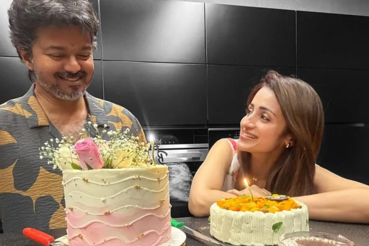 Trisha Krishnan and Vijay posing together at a party.