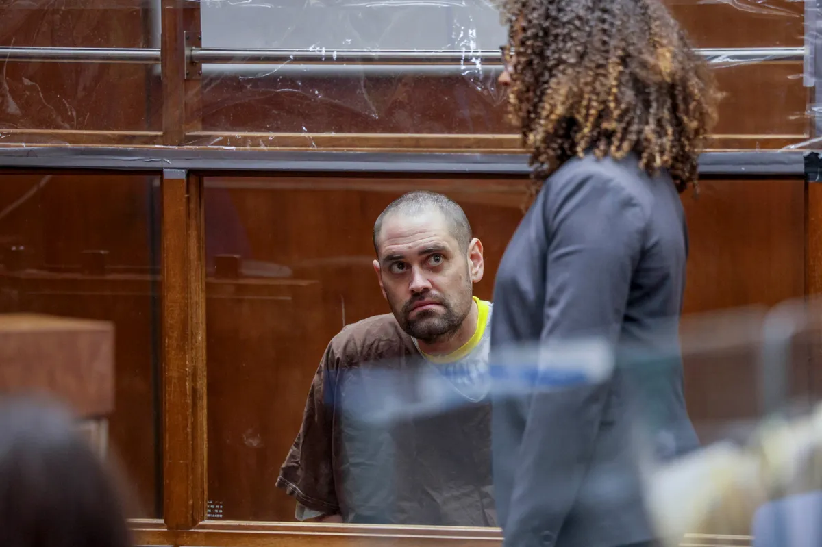 A young man looking stressed in a courtroom.
