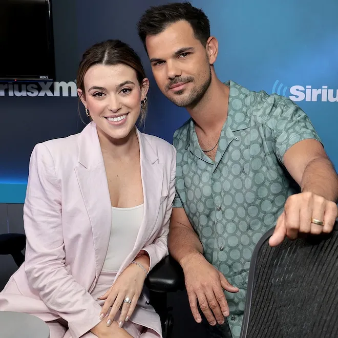 Taylor Lautner and Tay Lautner smiling, holding items related to their baby's sex reveal.