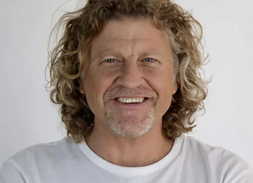 Patrick Davenport, a man with glasses, smiling for a professional photo.