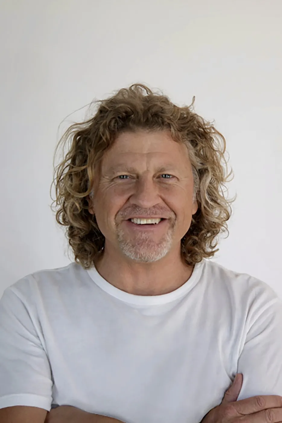 Patrick Davenport, a man with glasses, smiling for a professional photo.