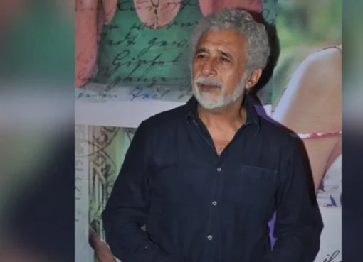 Naseeruddin Shah smiling.