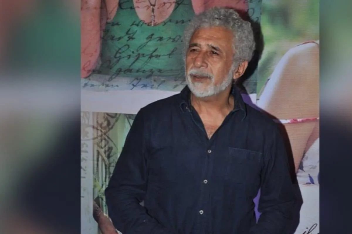 Naseeruddin Shah smiling.