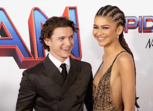 Zendaya and Tom Holland smiling together.