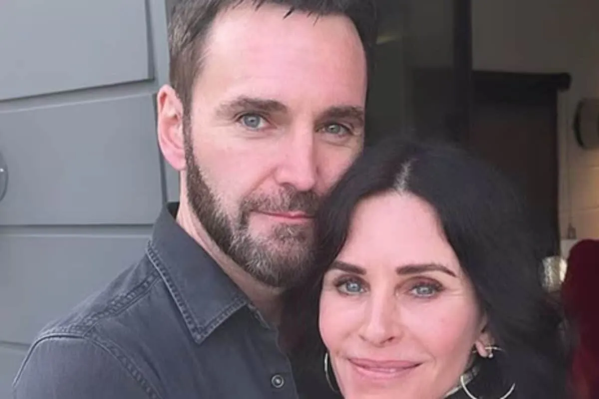 Courteney Cox and Johnny McDaid smiling together.
