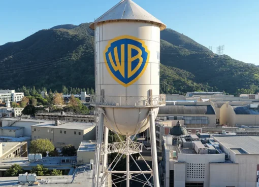 Photo of a senator's letter with movie studio logos in the background, signaling a merger delay.