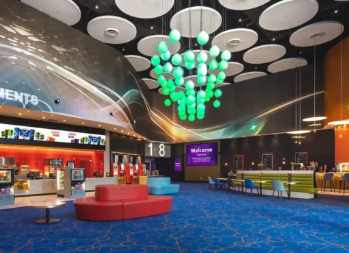 A vibrant, modern movie theater marquee with the Kinepolis logo and 'Showcase Cinemas' next to it, suggesting a new era.