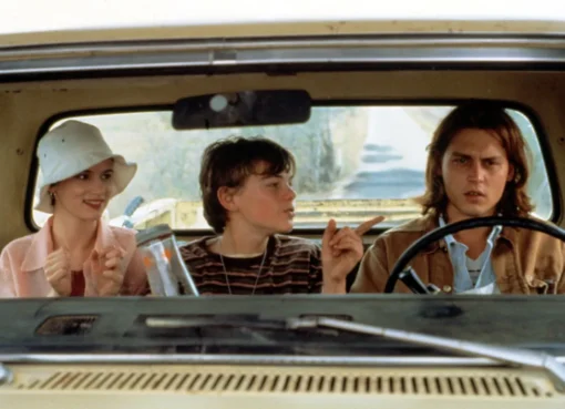 A theater marquee with the words 'What's Eating Gilbert Grape' and 'Musical Premiere' lit up.