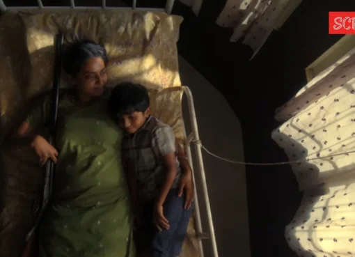 A still from the 'Balan The Boy' trailer showing a mother holding a gun.