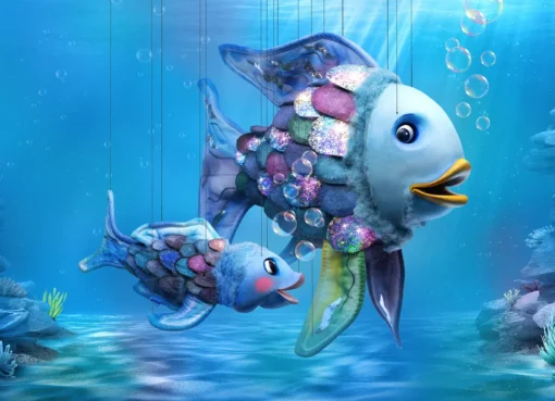 An animated image of The Rainbow Fish with shimmering, colorful scales swimming gracefully in the ocean.