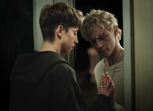 Promotional image for the movie 'Leviticus,' showing two young men with a dark, shadowy presence, possibly a demon.