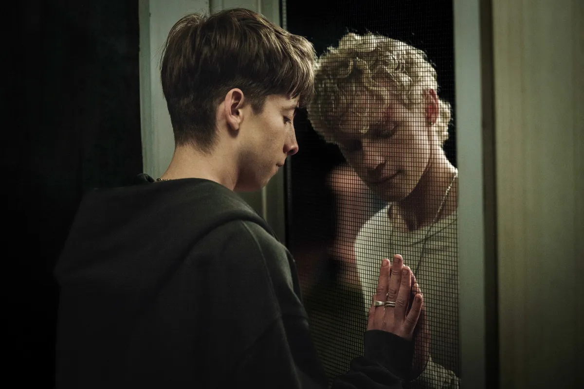 Promotional image for the movie 'Leviticus,' showing two young men with a dark, shadowy presence, possibly a demon.