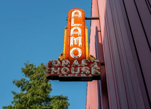 An Alamo Drafthouse movie screen with the company logo.