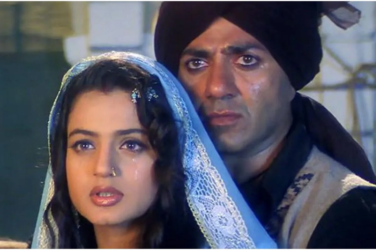 Ameesha Patel and Sunny Deol looking serious on the Gadar movie set, perhaps discussing a scene.