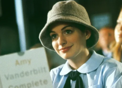 Anne Hathaway smiling, possibly looking regal and elegant, perhaps hinting at her Princess Diaries role.