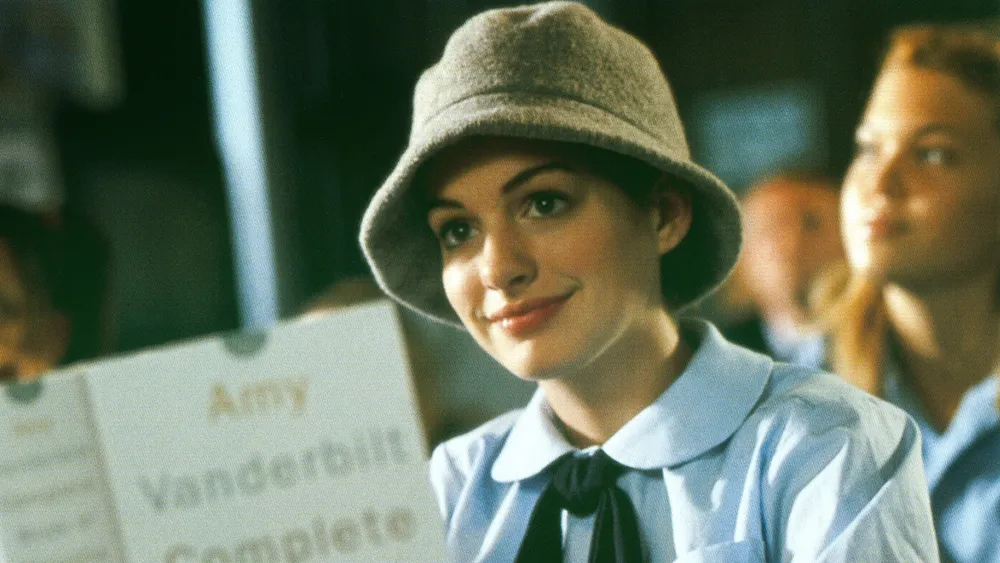 Anne Hathaway smiling, possibly looking regal and elegant, perhaps hinting at her Princess Diaries role.