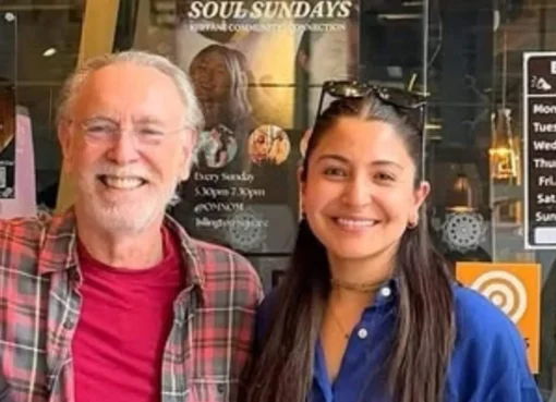 Anushka Sharma smiling at a restaurant in London with Krishna Das.