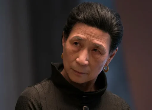 Wai Ching Ho in character as Madame Gao, looking calm and serious with a subtle smirk.