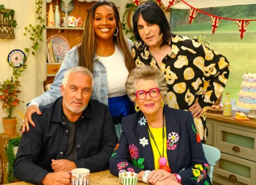 A colorful tent from the Great British Bake Off set, surrounded by green grass.