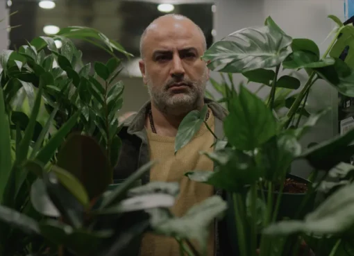 A film still showing a pensive doctor in a modern Iranian setting.