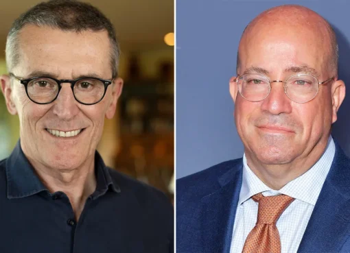 Jeff Zucker and Marco Bassetti looking at a professional presentation about media growth.