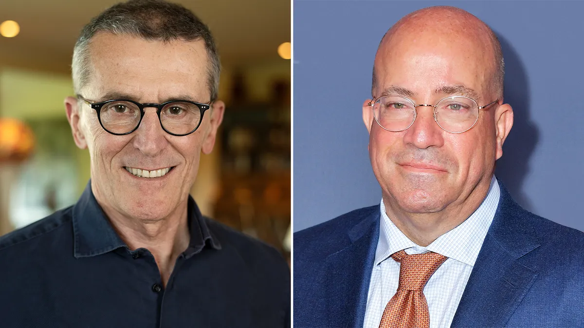 Jeff Zucker and Marco Bassetti looking at a professional presentation about media growth.
