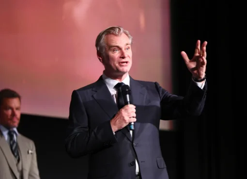 Christopher Nolan speaking at a film premiere, expressing a heartfelt dedication.