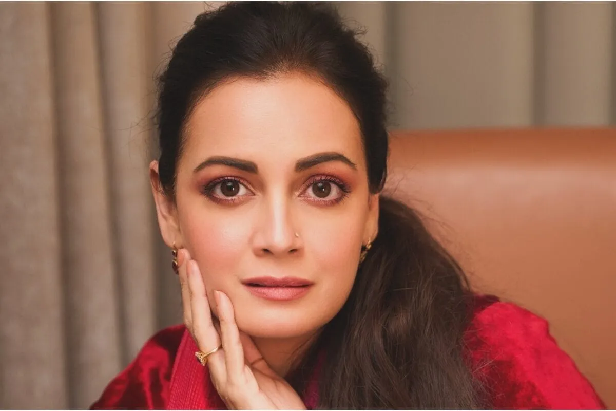 A beautiful photo of Dia Mirza smiling naturally at a press event