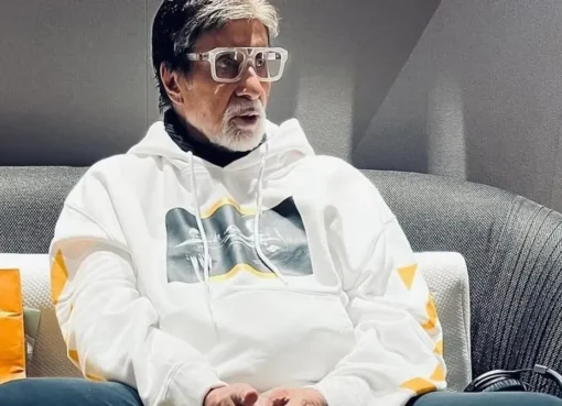 Amitabh Bachchan looking thoughtful and serious in a dark suit.