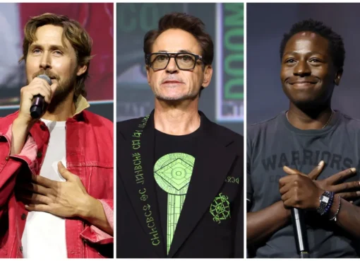 Crowd of excited fans cheering and looking at a large screen at Marvel's Comic-Con panel.