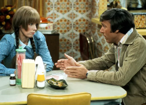 Louise Lasser wearing her signature braids and a dress from Mary Hartman, Mary Hartman.