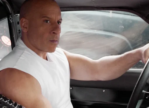 Vin Diesel looking tough next to a fast car
