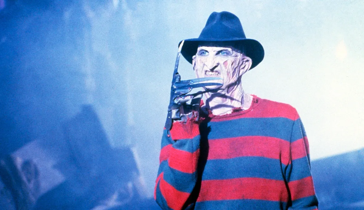 A close-up of Freddy Krueger's iconic razor glove, ready to strike.