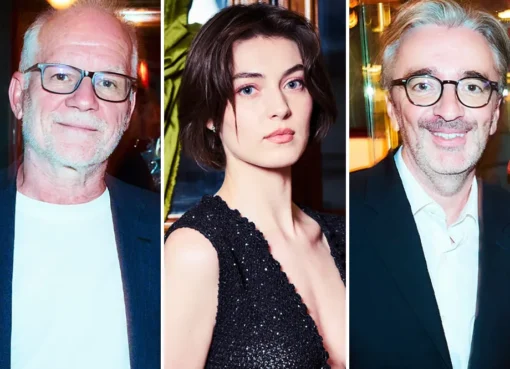 An elegant dinner gathering with several prominent figures from the French film industry in a classic Parisian restaurant.