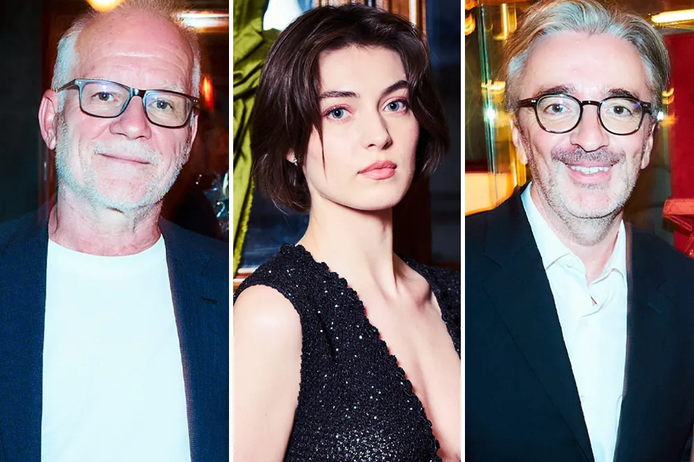 An elegant dinner gathering with several prominent figures from the French film industry in a classic Parisian restaurant.