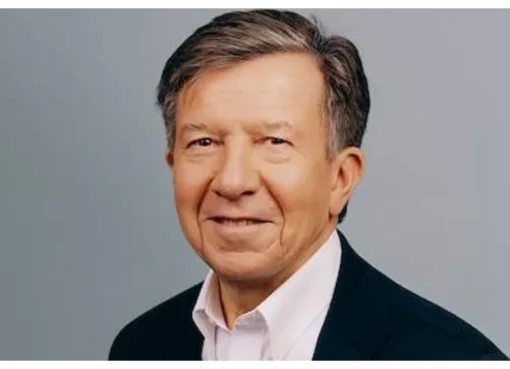 Gilles Pélisson, a man with short hair and glasses, smiles slightly, wearing a suit jacket.