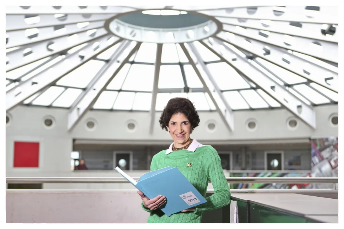 Close-up photo of Italian physicist Fabiola Gianotti smiling thoughtfully.
