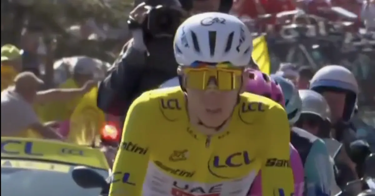 Tadej Pogacar in a yellow cycling jersey, smiling and celebrating his victory at the Tour de France.