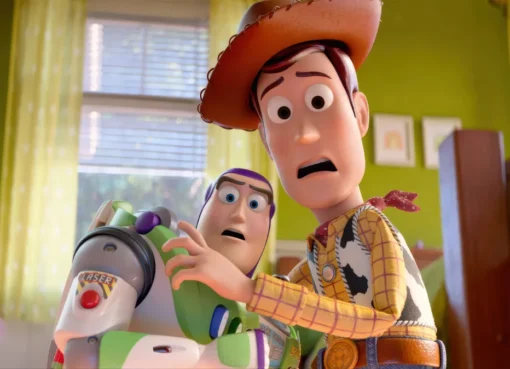 Woody and Buzz Lightyear smiling with other Toy Story characters in a celebratory pose.