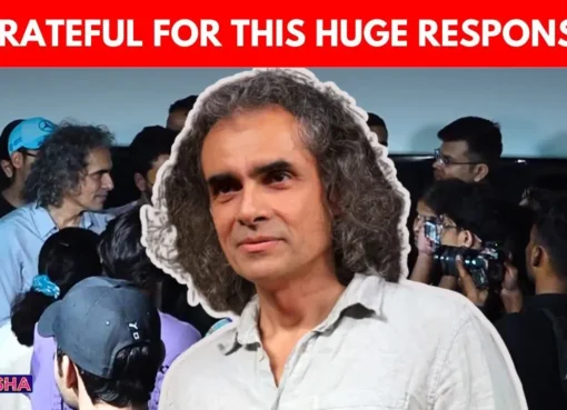 Imtiaz Ali smiling and interacting with happy fans inside a movie theatre.