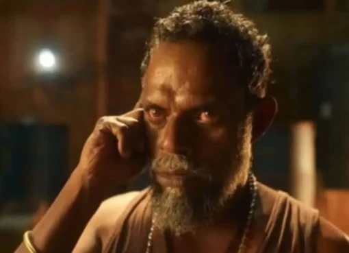 A close-up of actor Vinayakan looking serious