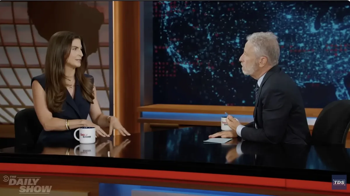 Kaitlan Collins talking on a late night talk show set