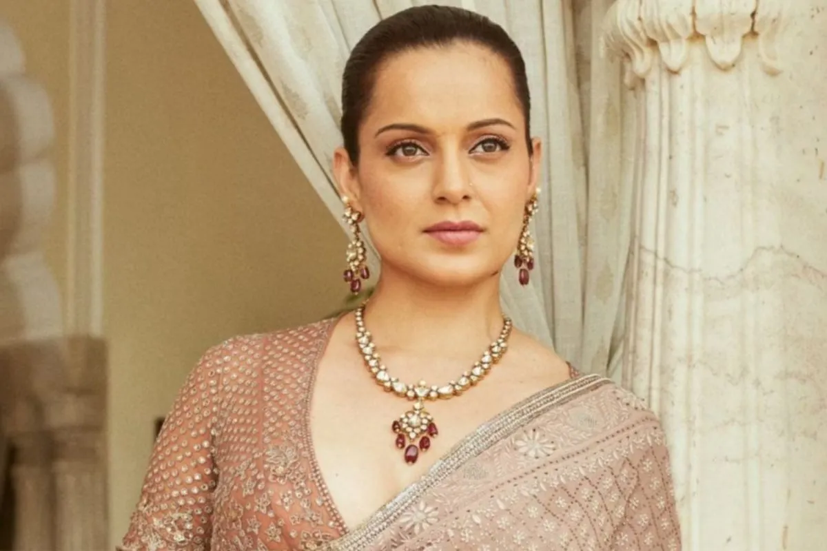 Kangana Ranaut speaking passionately, with a colorful background.