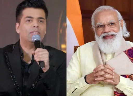 Karan Johar smiling widely, looking happy and honored.